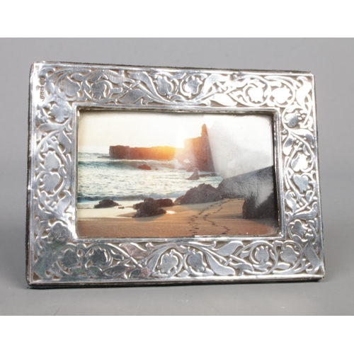 588 - A London silver photo frame decorated with floral motifs. Dated 1985.