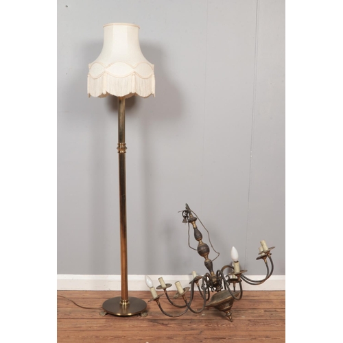 594 - A brass eight branch chandelier together with a brass standard lamp with circular base and lion paw ... 