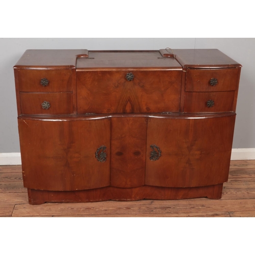 597 - A mid 20th century cocktail cabinet with mirrored interior.