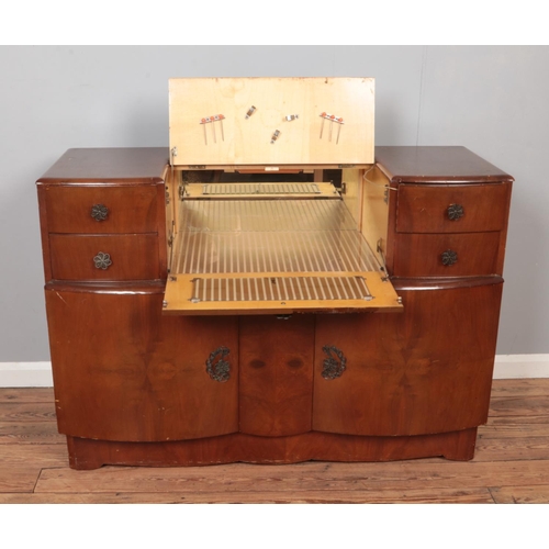 597 - A mid 20th century cocktail cabinet with mirrored interior.