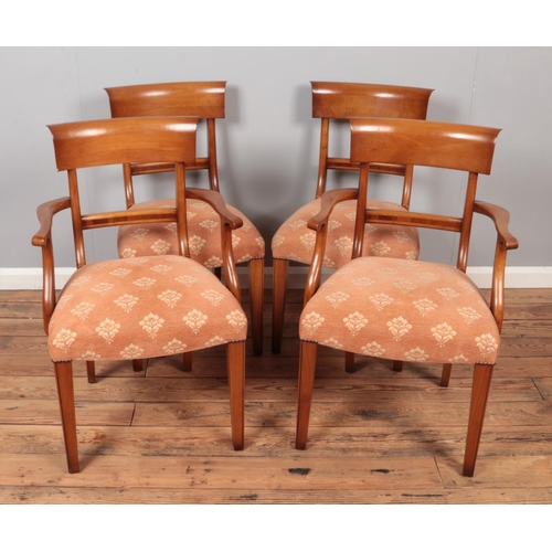 600 - A set of four bar back dining chairs with upholstered seats including two carvers