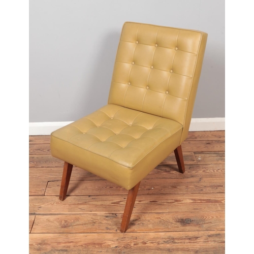 611 - A vintage Scandinavian style beige leatherette chair with teak legs.