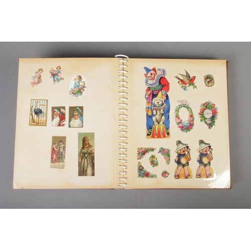 184 - A large scrap album with Egyptian design filled with Victorian and later scraps of various themes in... 