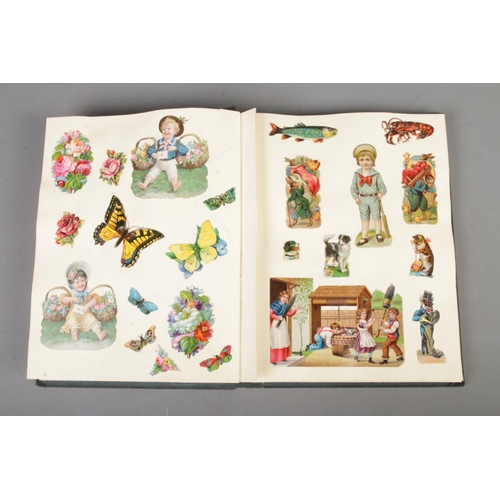 185 - A scrap book album filled with Victorian and late scraps of various themes including horses, childre... 