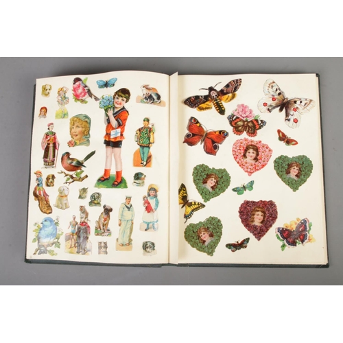 185 - A scrap book album filled with Victorian and late scraps of various themes including horses, childre... 