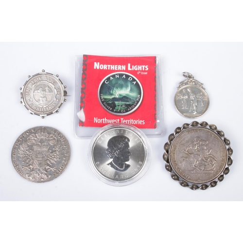 571 - A small collection of silver coins and fobs, to include badge mounted 1819 George III crown, 2018 Ca... 