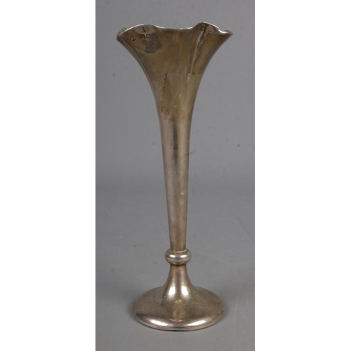 576 - A silver stem vase with fluted top on circular foot with weighted base assayed Birmingham 1907. 73.7... 