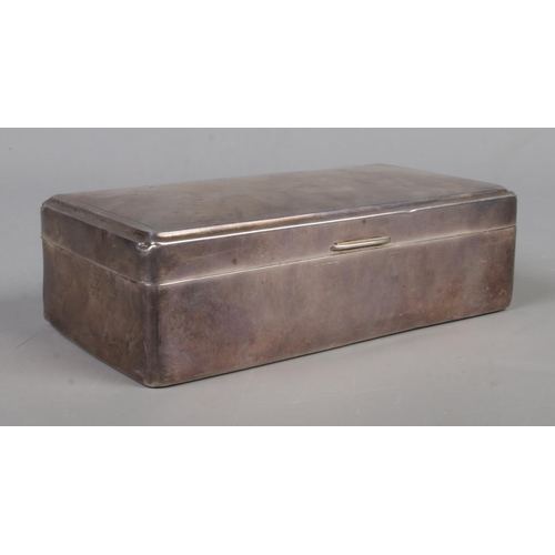 580 - A hinged silver mounted cigarette box with engine turned decoration and 'A' monogram to the top righ... 