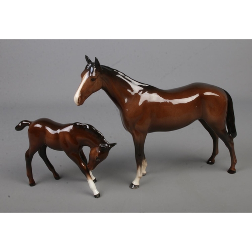 585 - A Beswick figure of a horse together with young foal.

Horse Height 20cm