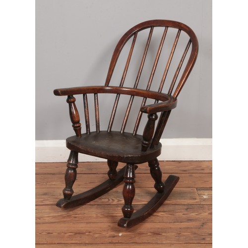 610 - A Victorian child's spindle back Windsor rocking chair.