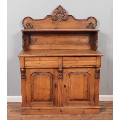 604 - A Victorian pine chiffonier, with cupboard door base and carved scrolled detailing. Height: 145cm, W... 