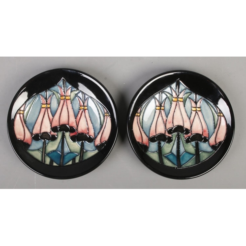 106 - A pair of Moorcroft pottery pin dishes/coasters decorated in a floral design by Kerry Goodwin. Date ... 