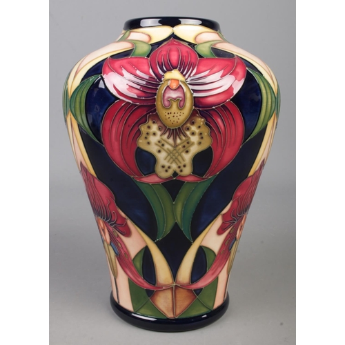 118 - A Moorcroft pottery vase decorated in the Twilight Orchid pattern by Rachel Bishop. Date cypher for ... 