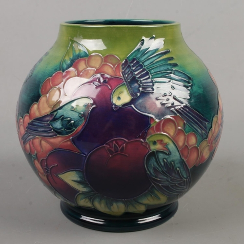 12 - A Moorcroft pottery vase decorated in the Finch And Berry pattern. Date cypher for 1992. Height 16.5... 
