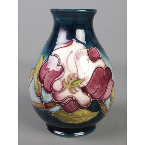 125 - A Moorcroft pottery vase decorated in the Magnolia pattern by Sue Pointon. Date cypher for 1991. Hei... 