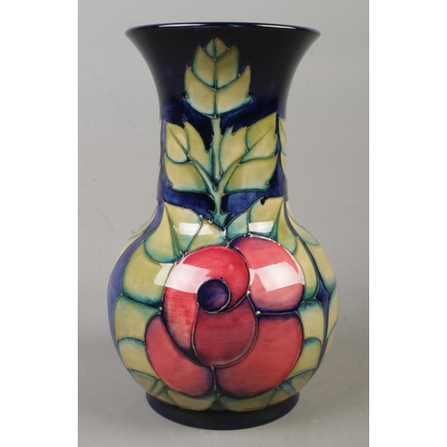 134 - A Moorcroft pottery vase decorated in the Rose pattern by Sally Tuffin. Date cypher for 1990. Height... 