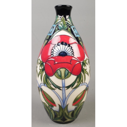 55 - A Moorcroft pottery trial vase decorated with Poppies. Date cypher for 2016. Height 24cm.