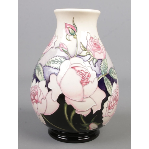 73 - A Moorcroft pottery trial vase decorated with roses. Date cypher for 2017. Height 19cm.