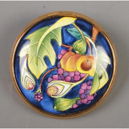 78 - A Moorcroft Enamels brooch by Emma Bossons. In original box. Diameter 3.6cm.