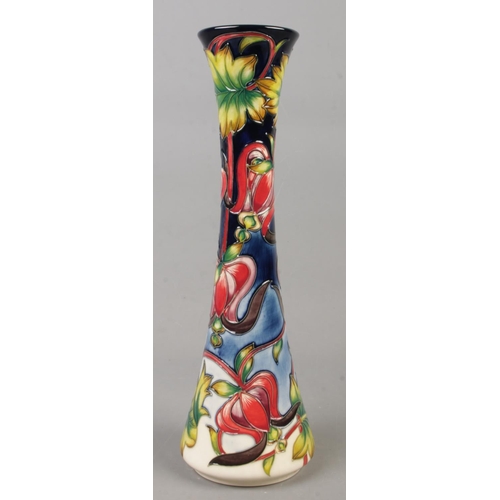 8 - A Moorcroft pottery designer trial vase decorated with red flowers and leaves. Date cypher for 2003.... 