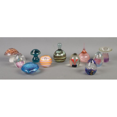 10 - Eleven glass paperweights, to include Mdina, Wedgwood mushroom and swirl examples.