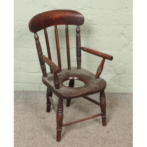 585 - A Victorian oak child's potty chair.