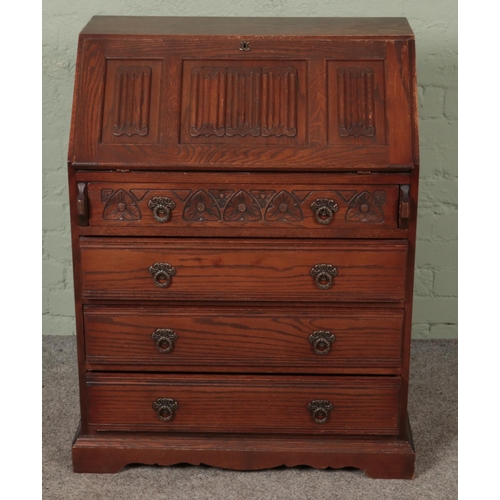 587 - An Old Charm carved oak bureau.