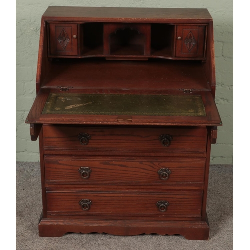 587 - An Old Charm carved oak bureau.