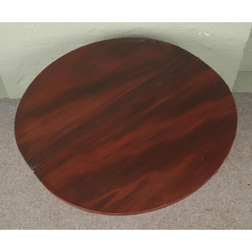 593 - A mahogany fold over card table of demi-lune form on turned pedestal base.

Hx73cm
Wx99cm
Dx50cm