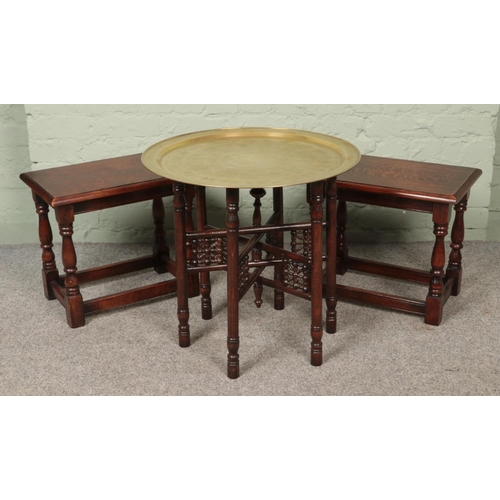 596 - A middle Eastern brass circular topped table with wooden folding base along with two oak side tables... 