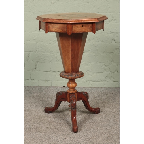 599 - A Victorian walnut sewing table of trumpet form raised on scroll carved splayed supports with mother... 