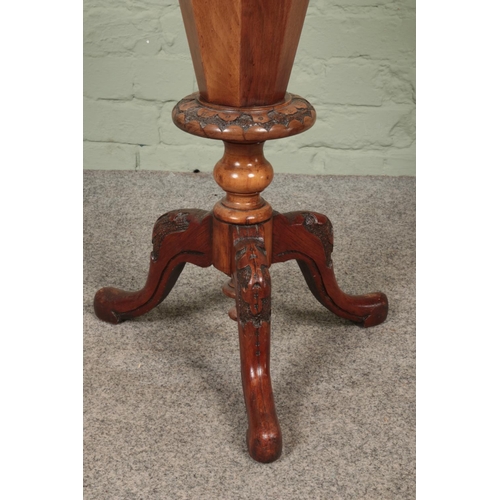 599 - A Victorian walnut sewing table of trumpet form raised on scroll carved splayed supports with mother... 