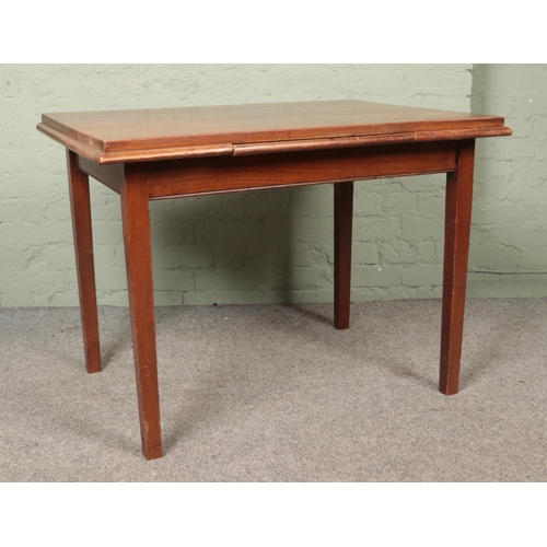 600 - A mahogany table with central slide and square tapering legs