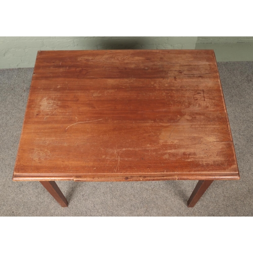 600 - A mahogany table with central slide and square tapering legs