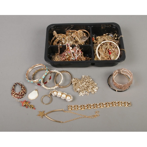 113 - A tray of gold tone costume jewellery and accessories to include necklaces, earrings, bangles, keyri... 