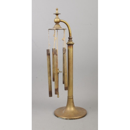 50 - An early Twentieth Century set of brass table chimes, on circular base and swan neck. Height: 43cm.