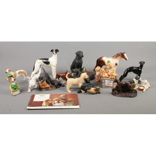 65 - A collection of ceramic and composite figure groups, mainly depicting dogs. To include Leonardo, Fra... 