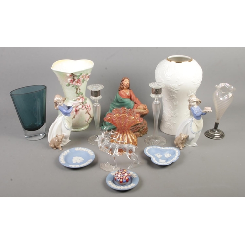 69 - A quantity of ceramics and glassware. Includes silver collared candlesticks, Nao figures, Slyvac vas... 