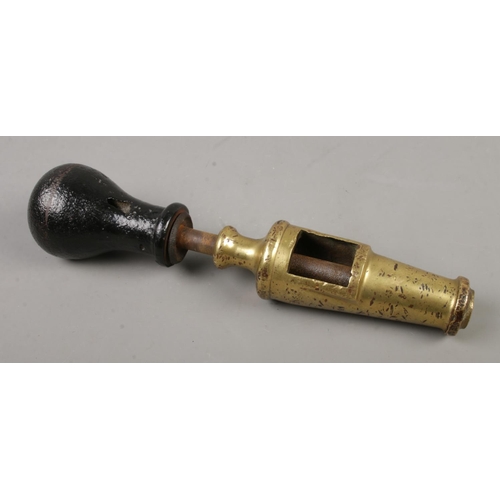 7 - An antique wine corker in brass and cast iron
