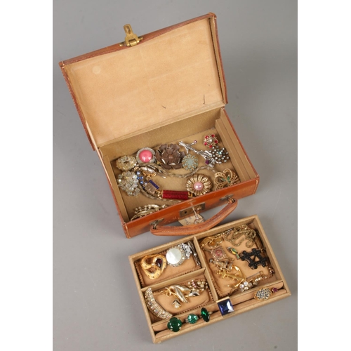 84 - A Viking leather jewellery box with contents. Includes vintage brooches, dress rings, etc.