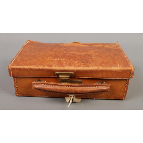 84 - A Viking leather jewellery box with contents. Includes vintage brooches, dress rings, etc.