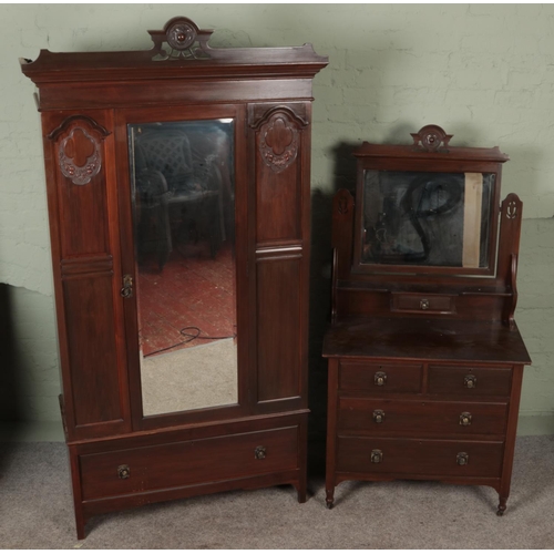 578 - An early 20th century carved mahogany two piece bedroom suite. Comprising of mirror front wardrobe a... 