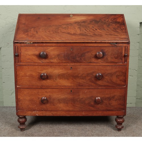 579 - A Victorian three drawer mahogany bureau raised on turned supports. Height: 117cm, Width: 106cm, Dep... 