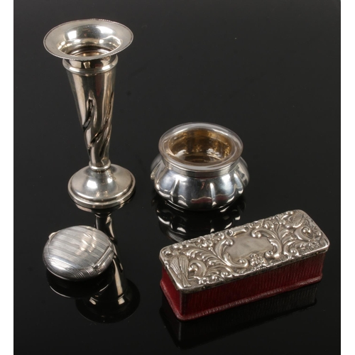 536 - A collection of silver including pill box, candle stick, salt with glass interior and wooden box wit... 