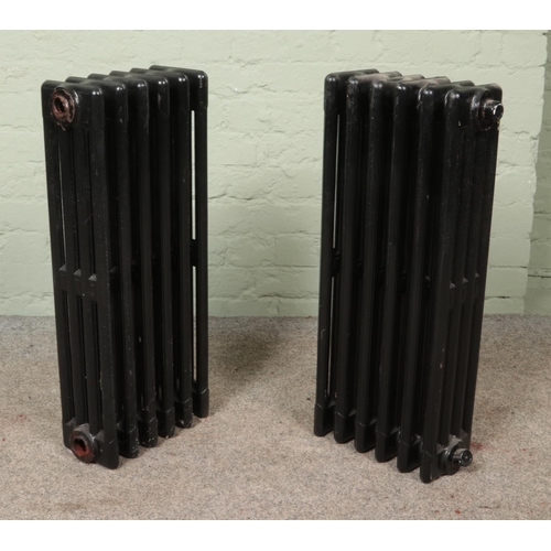 345 - Two painted six-bar cast iron radiators. Height: 75cm.