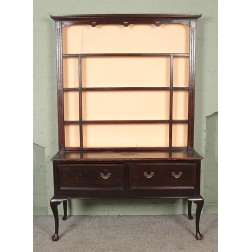 581 - An 18th century style oak dresser with cabriole legs, two deep drawers and plate rack top. Hx208cm W... 