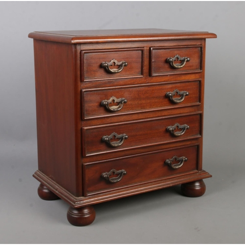 A miniature mahogany chest of drawers in the Victorian style. 39cm x 36cm x 23cm.