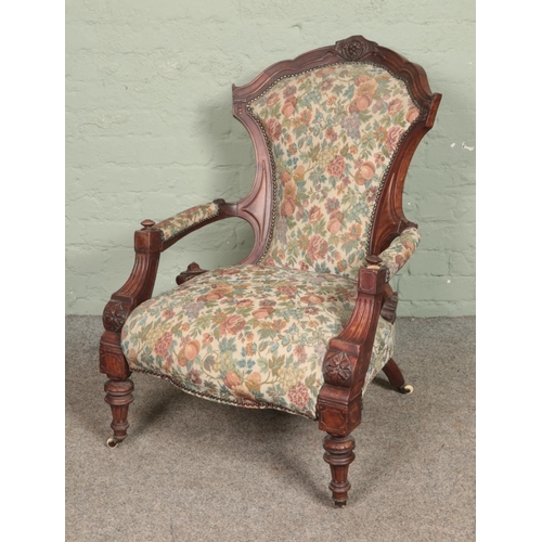 569 - A Victorian carved mahogany armchair with tapestry upholstery.