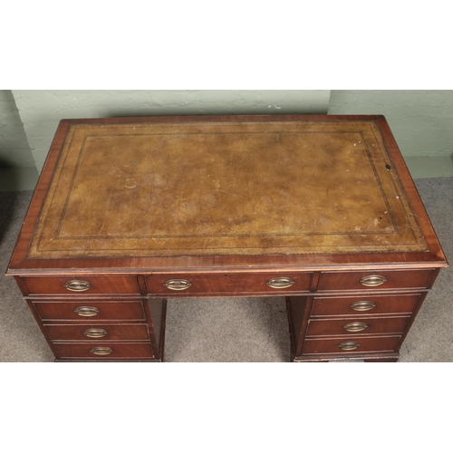 571 - A large mahogany pedestal writing desk with inset tooled leather top and Hepplewhite style oval plat... 