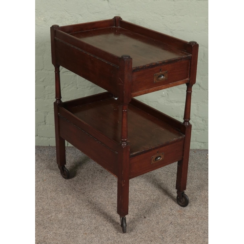 577 - An early 20th century mahogany tea trolley with two drawers.